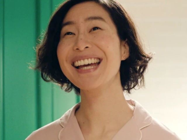 Smiling person in pink shirt against a green door background.